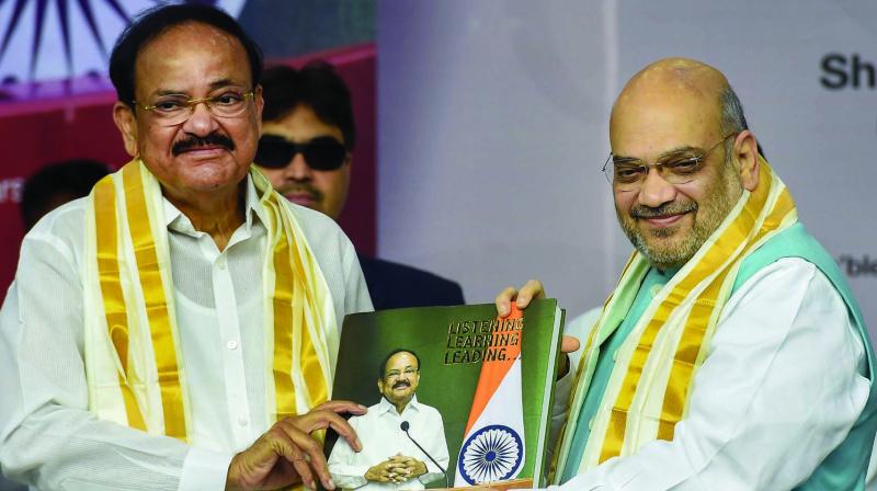 Home minister Amit Shah releases a book chronicling vice-president M. Venkaiah Naidus two years in office in Chennai on Sunday. 	(Photo: PTI)