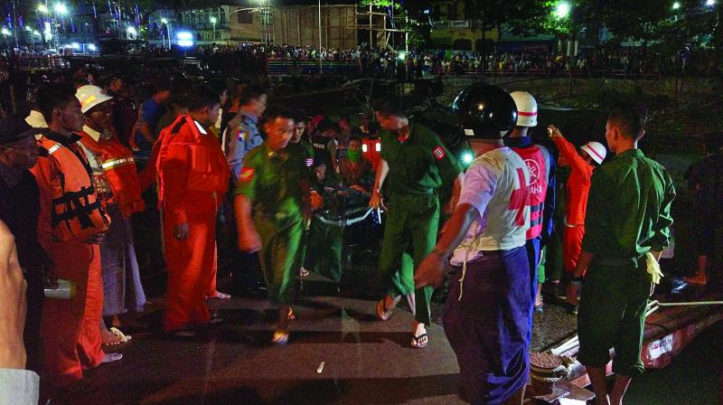 Myanmar soldiers and members of a rescue team carry the body of a ferry passenger in Pathein, Myanmar, on Saturday. (Photo: AFP)