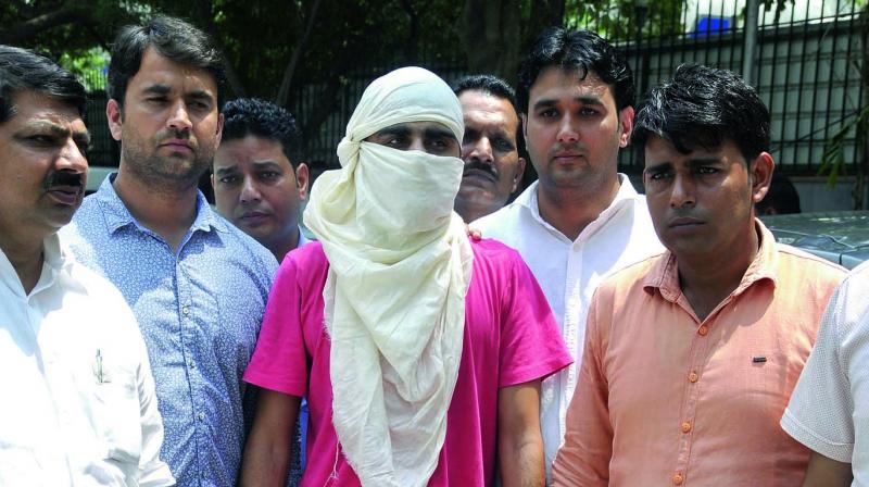 Delhi police crime branch officers with the arrested gangster of Neeraj Bawana gang. (Photo: Bunny Smith)