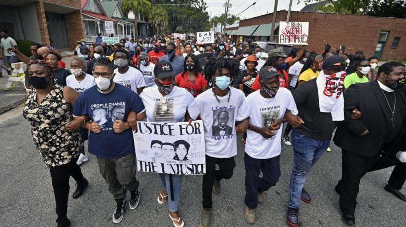 Protesters march after a rally at the Glynn County Courthouse to protest the shooting of Ahmaud Arbery. (AP) Protesters march after a rally at the Glynn County Courthouse to protest the shooting of Ahmaud Arbery. (AP)
