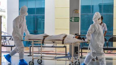 Hospital staff shifts a COVID-19 patient to a special ward for treatment. (PTI)