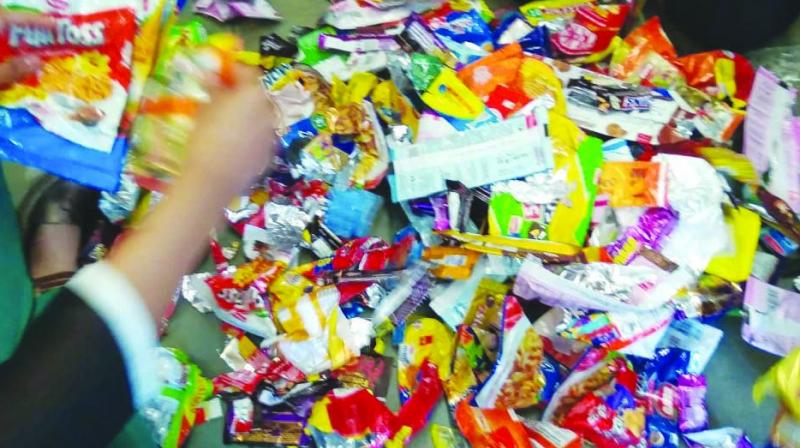 Waste packets of chips, biscuits, and chocolates. Waste packets of chips, biscuits, and chocolates.