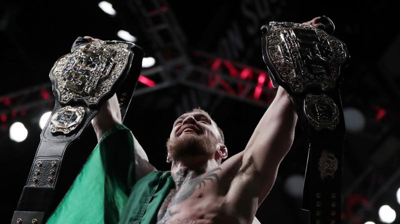 Conor McGregor becomes 1st fighter to hold 2 UFC titles
