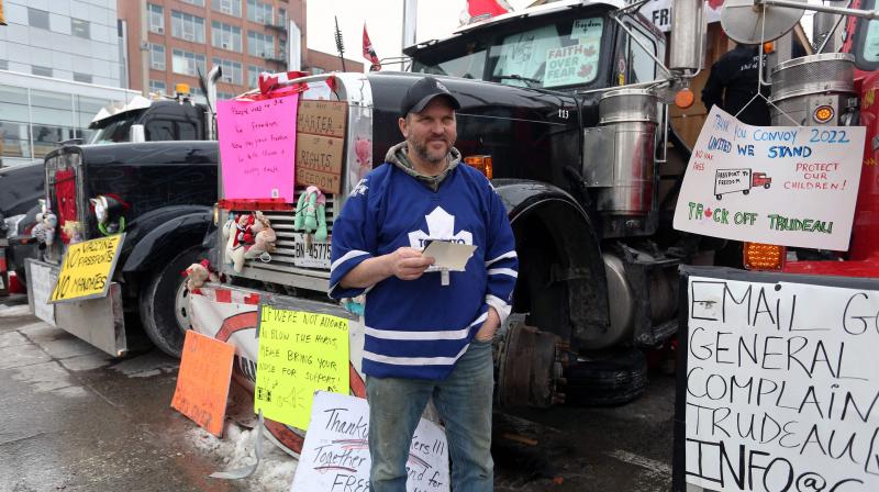 Trucker Jay Vanderwier stands in front of his truck as demonstrators continue to protest the vaccine mandates implemented by Prime Minister Justin Trudeau, on February 8, 2022 in Ottawa, Canada. (AFP) Trucker Jay Vanderwier stands in front of his truck as demonstrators continue to protest the vaccine mandates implemented by Prime Minister Justin Trudeau, on February 8, 2022 in Ottawa, Canada. (AFP)