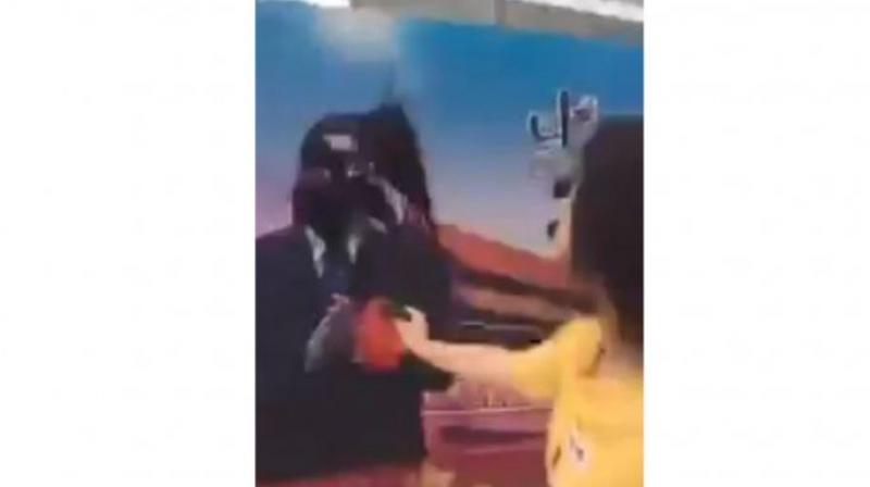 In the video, Dong Yaoqiong splashes ink on a poster bearing President Xis image at a location in Shanghais financial district, saying defiantly: Xi Jinping, Im right here waiting for you to arrest me.  (Photo: Screengrab from Twitter/Huayong798)