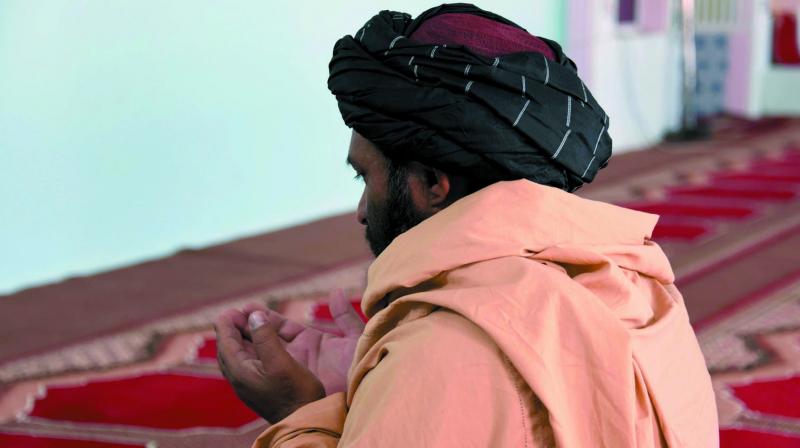 A file photo of former Taliban commander Maulvi Abdul Rauf offering prayers in a mosque in Panjwayi, Kandahar. (Photo: AFP)