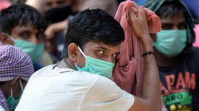 Guest workers gather at an assembling centre to get transferred to a railway station to board on a special train to Bihar after the government eased a nationwide lockdown imposed as a preventive measure against the COVID-19 coronavirus, in Chennai. PTI Photo