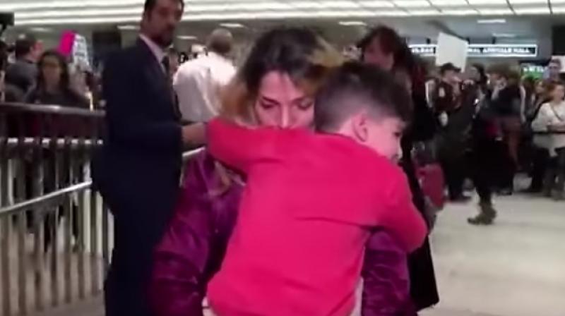 The boy reunited with his mom after he was detained for hours at the airport. (Photo: YouTube)