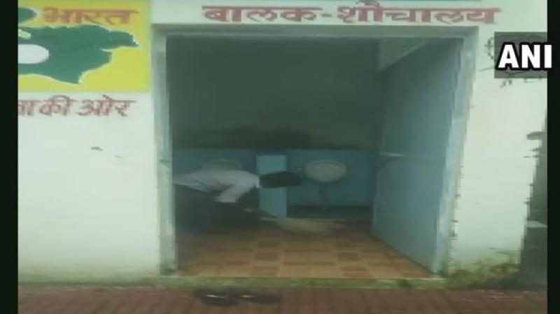 When asked about the incident District Magistrate Tanvi Sundriyal said: If students are given practical education on cleanliness in schools and are involved in such activities theres nothing wrong about it. (Photo: Twitter | ANI)