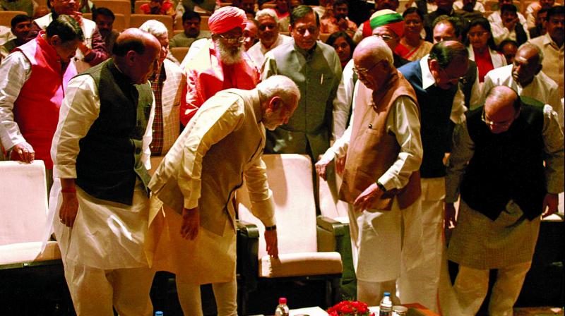 Prime Minister Narendra Modi guides senior leader L.K. Advani to his seat at the BJP parliamentary party meeting in New Delhi on Tuesday. (Pritam Bandyopadhyay) Prime Minister Narendra Modi guides senior leader L.K. Advani to his seat at the BJP parliamentary party meeting in New Delhi on Tuesday. (Pritam Bandyopadhyay)