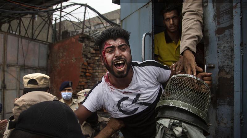 Policemen detain a Kashmiri Shiite Muslim as he attempts, along with others, to take out a religious procession in Srinagar Policemen detain a Kashmiri Shiite Muslim as he attempts, along with others, to take out a religious procession in Srinagar