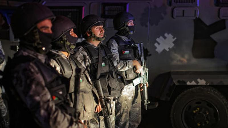 Jordanian security forces stand next to their armored vehicle at the scene next to Karak Castle, during an ongoing attack, in the central town of Karak, about 140 kilometers (87 miles) south of the capital Amman in Jordan. (Photo: AP)