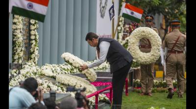 Maharashtra Dy CM Devendra Fadnavis pays tribute to the martyrs who laid down their lives while fighting terrorists during 26/11 attack, on its 15th anniversary in Mumbai, Sunday, Nov. 26, 2023. (PTI Photo/Kunal Patil)
