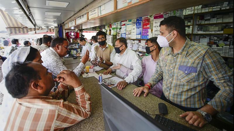 Salesmen at a chemist shop wear protective masks, in wake of the deadly novel coronavirus, outside Safdarjung Hospital, in New Delhi, Wednesday, March 4, 2020. (Photo | PTI) 