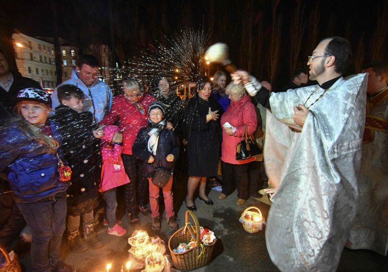 An Orthodox priest blesses believers and their traditional Easter cakes and painted eggs during an Orthodox Easter ceremony at the Volodymyrsky Cathedral in Kiev on April 7, 2018. Easter is popularly known as Pascha in the Orthodox tradition. (Photo: AFP) An Orthodox priest blesses believers and their traditional Easter cakes and painted eggs during an Orthodox Easter ceremony at the Volodymyrsky Cathedral in Kiev on April 7, 2018. Easter is popularly known as Pascha in the Orthodox tradition. (Photo: AFP)
