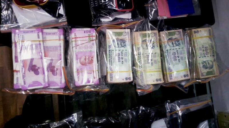 Police showing the cash recovered from BJP Leader Manish Sharma in Kolkata. (Photo: PTI) Police showing the cash recovered from BJP Leader Manish Sharma in Kolkata. (Photo: PTI)