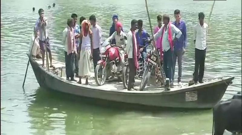 Surrounded by river Budhigandak on three sides, the village in Begusarai district has a single road which connects it to the rest of the state. (Photo: ANI) Surrounded by river Budhigandak on three sides, the village in Begusarai district has a single road which connects it to the rest of the state. (Photo: ANI)