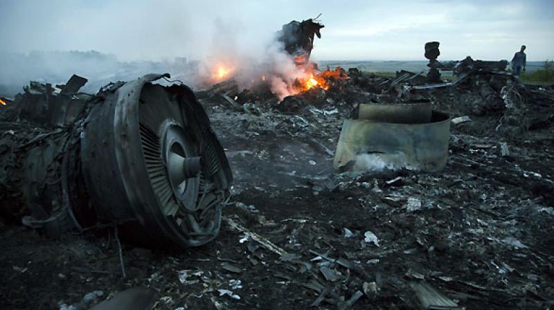 A man walks amongst the debris at the crash site of a passenger plane near the village of Hrabove, Ukraine. (Photo: AP) A man walks amongst the debris at the crash site of a passenger plane near the village of Hrabove, Ukraine. (Photo: AP)