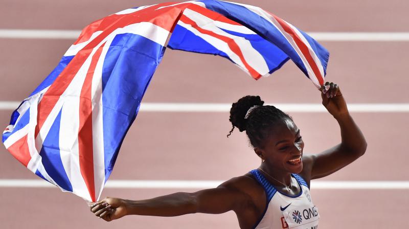 Gold medallist Dina Asher-Smith of Great Britain celebrates with the Union flag after winning the womens 200-meter final at the World Athletics Championships in Doha, Qatar. AP Photo