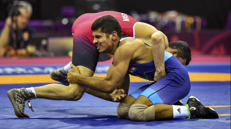 WHAT SOCIAL DISTANCING? Indian wrestler Rahul Balasaheb Aware (Blue) during his bout against Iran’s Majid Almas Dastan at Asian Wrestling Championships in New Delhi. PTI Photo WHAT SOCIAL DISTANCING? Indian wrestler Rahul Balasaheb Aware (Blue) during his bout against Iran’s Majid Almas Dastan at Asian Wrestling Championships in New Delhi. PTI Photo