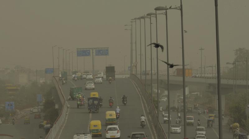 Vehicles ply slowly on a road as dust envelopes the sky over New Delhi, on Wednesday. (Photo: PTI) Vehicles ply slowly on a road as dust envelopes the sky over New Delhi, on Wednesday. (Photo: PTI)