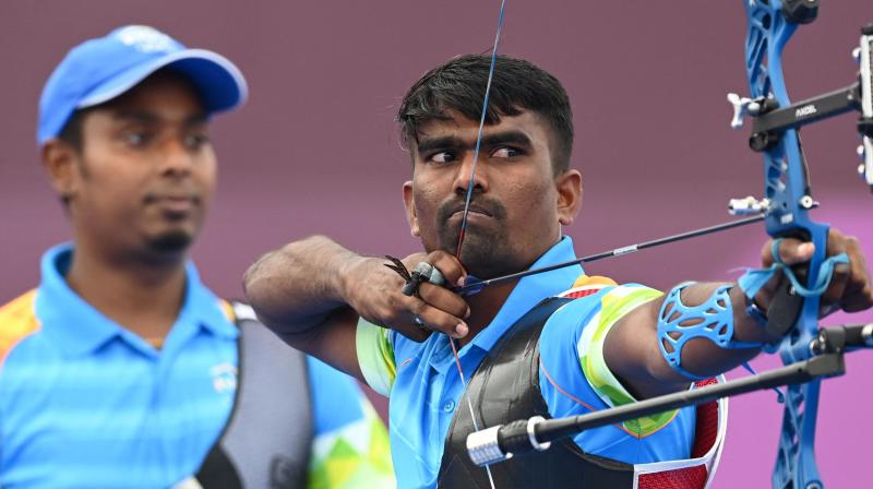 Indias Pravin Jadhav (right) and Atanu Das compete in the mens team eliminations during the Tokyo Olympic Games at Yumenoshima Park Archery Field in Tokyo on Monday. (Photo: AFP)