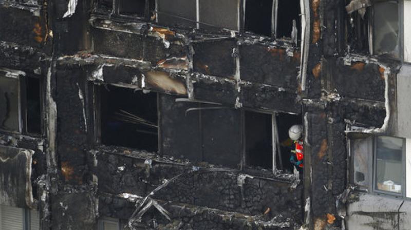A firefighter stands outside of the Grenfell Tower after fire engulfed the 24-storey building, in London. (Photo: AP) A firefighter stands outside of the Grenfell Tower after fire engulfed the 24-storey building, in London. (Photo: AP)