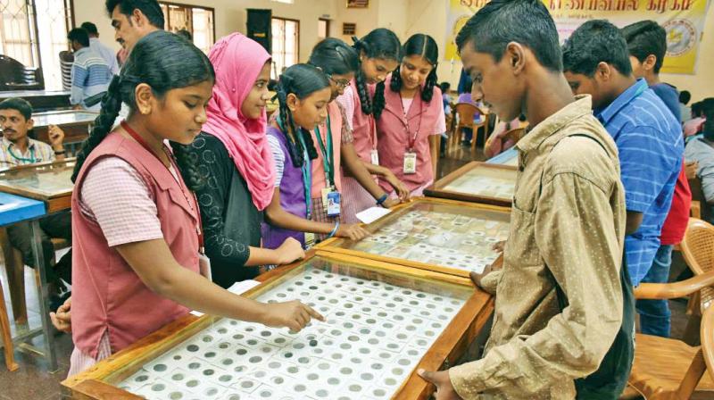 School students looking at the coins displayed at numimatic exhibition at Thanjavur on Friday. (Photo: DC) School students looking at the coins displayed at numimatic exhibition at Thanjavur on Friday. (Photo: DC)