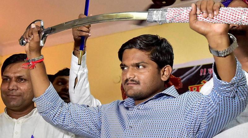 Hardik Patel had earlier set a condition that he would support the Congress in the Assembly polls, due next month, only if the party committed to reservation in education and government jobs for his community. (Photo: PTI/File) Hardik Patel had earlier set a condition that he would support the Congress in the Assembly polls, due next month, only if the party committed to reservation in education and government jobs for his community. (Photo: PTI/File)