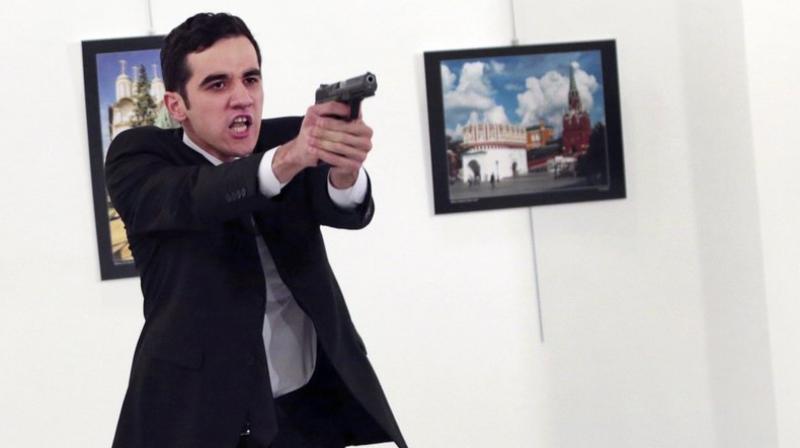 A man identified as Mevlut Mert Altintas holds up a gun after shooting Andrei Karlov, the Russian Ambassador. (Photo: AP) A man identified as Mevlut Mert Altintas holds up a gun after shooting Andrei Karlov, the Russian Ambassador. (Photo: AP)