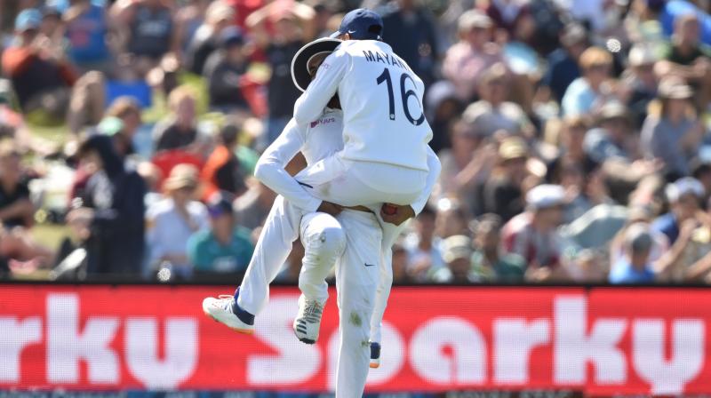 Ravindra Jadeja (L) celebrates with teammate Mayank Agarwal (R) after catching out New Zealands Neil Wagner (not pictured) on day two of the second Test cricket match between New Zealand and India at the Hagley Oval in Christchurch on Sunday. AFP photo