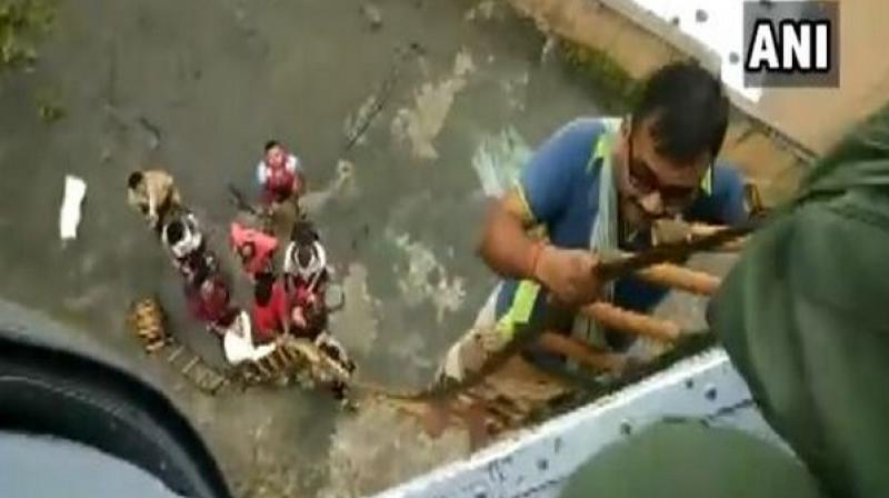 IAF with help of its Mi17 helicopter also airlifted nine personnel stranded on the rooftop of a building. Also, Army, Navy and Air Force teams provided packed food and water to all the rescued personnel. (Photo: ANI | Representative) IAF with help of its Mi17 helicopter also airlifted nine personnel stranded on the rooftop of a building. Also, Army, Navy and Air Force teams provided packed food and water to all the rescued personnel. (Photo: ANI | Representative)
