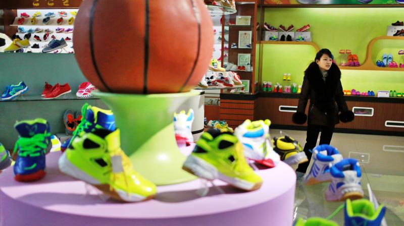 A guide stands near a basketball shoe display in a product exhibition room at the Ryuwon Shoe Factory that specialises in sports footwear, in Pyongyang. (Photo: AP) A guide stands near a basketball shoe display in a product exhibition room at the Ryuwon Shoe Factory that specialises in sports footwear, in Pyongyang. (Photo: AP)