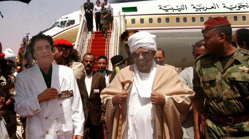 In this May 10, 2001, file photo, Libyan leader Moammar Gadhafi , left, is greeted by President Omar El-Bashir, center, upon his arrival in Khartoum. (Photo:AP) In this May 10, 2001, file photo, Libyan leader Moammar Gadhafi , left, is greeted by President Omar El-Bashir, center, upon his arrival in Khartoum. (Photo:AP)