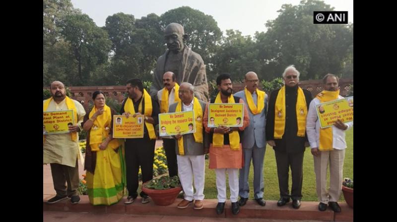 As part of protest, scores of TDP leaders were seen walking with placards and festoons through streets displaying various reasons and factors as to why Andhra should be given special status. (Photo:ANI) As part of protest, scores of TDP leaders were seen walking with placards and festoons through streets displaying various reasons and factors as to why Andhra should be given special status. (Photo:ANI)