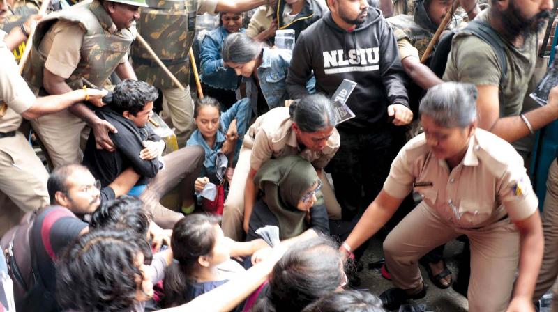 Protesters being taken away by policemen from near the Town Hall area in Bengaluru on Thursday. (Photo: KPN)