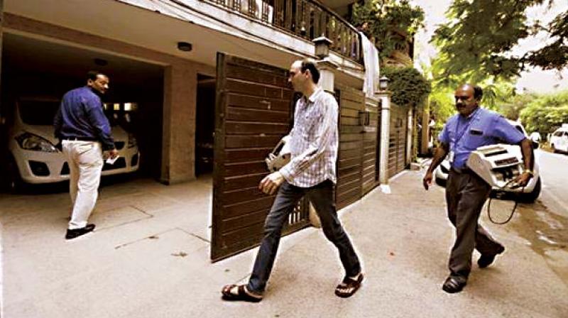 IT sleuths at D K Shivakumar’s house in Sadashiv Nagar on Wednesday. IT sleuths at D K Shivakumar’s house in Sadashiv Nagar on Wednesday.