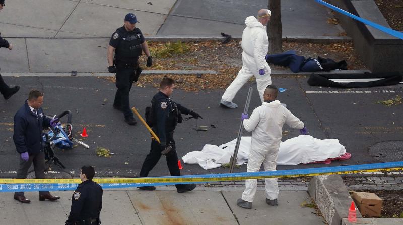 Authorities investigate the scene near a covered body on a bike path after a motorist drove onto the path near the World Trade Center memorial, striking and killing several people in New York. (Photo: AP) Authorities investigate the scene near a covered body on a bike path after a motorist drove onto the path near the World Trade Center memorial, striking and killing several people in New York. (Photo: AP)