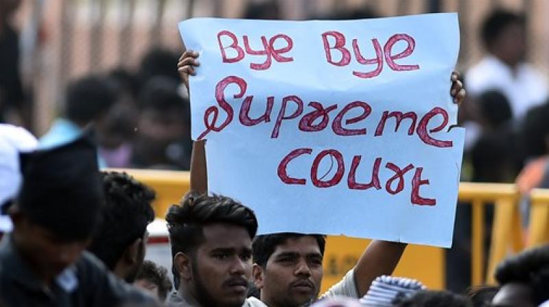 Youngsters and students during the protest to lift ban on jallikattu and impose ban on PETA, at Kamarajar Salai, Marina Beach in Chennai on Saturday. (Photo: PTI) Youngsters and students during the protest to lift ban on jallikattu and impose ban on PETA, at Kamarajar Salai, Marina Beach in Chennai on Saturday. (Photo: PTI)