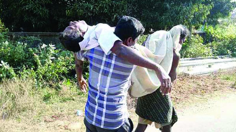 Sarat Barik of Kothasahi village in Odisha carries his father’s body on his shoulders due to the unavailability of hearse at the local health centre. Sarat Barik of Kothasahi village in Odisha carries his father’s body on his shoulders due to the unavailability of hearse at the local health centre.