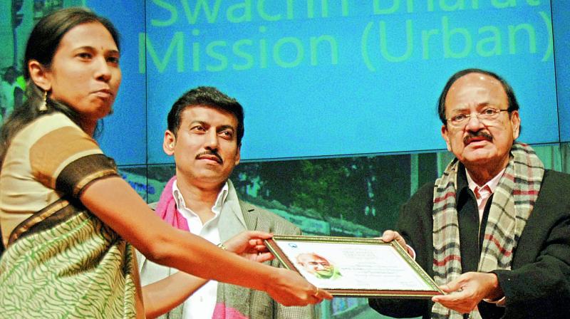 Union minister for urban development M. Venkaiah Naidu hands over the Open Defaecation-free city award under Swachh Bharat to municipal commissioner S. Nagalakshmi in Delhi on Thursday. Minister of state for information and broadcasting Colonel Rajyavardhan Singh Rathore is also seen. Union minister for urban development M. Venkaiah Naidu hands over the Open Defaecation-free city award under Swachh Bharat to municipal commissioner S. Nagalakshmi in Delhi on Thursday. Minister of state for information and broadcasting Colonel Rajyavardhan Singh Rathore is also seen.