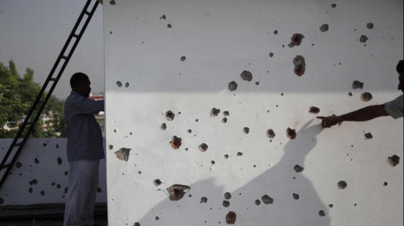 A villager points to marks made on a wall allegedly from firing from the Pakistan side of the border. (Photo: PTI) A villager points to marks made on a wall allegedly from firing from the Pakistan side of the border. (Photo: PTI)