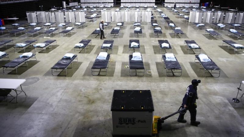 A worker moves items at a Federal Medical Station for hospital surge capacity set up at Temple University's Liacouras Center in Philadelphia. (Photo- AP) A worker moves items at a Federal Medical Station for hospital surge capacity set up at Temple University's Liacouras Center in Philadelphia. (Photo- AP)