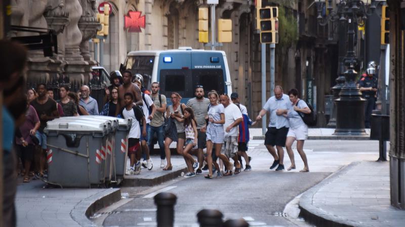 People flee from the scene after a white van jumped the sidewalk in the historic Las Ramblas district of Barcelona, Spain, crashing into a summer crowd of residents and tourists Thursday. (Photo: AP) People flee from the scene after a white van jumped the sidewalk in the historic Las Ramblas district of Barcelona, Spain, crashing into a summer crowd of residents and tourists Thursday. (Photo: AP)