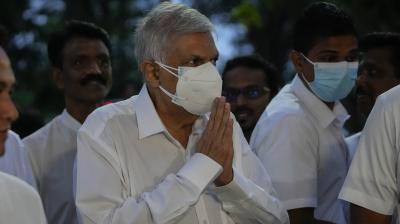 President elect Ranil Wickremesinghe greats supporters upon his arrival at a buddhist temple in Colombo, Sri Lanka, Wednesday, July 20, 2022. (AP)