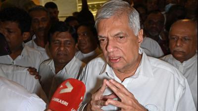 Sri Lanka's new president Ranil Wickremesinghe addresses the media representatives during his visit at the Gangaramaya Buddhist temple in Colombo. (Photo by Arun SANKAR / AFP)