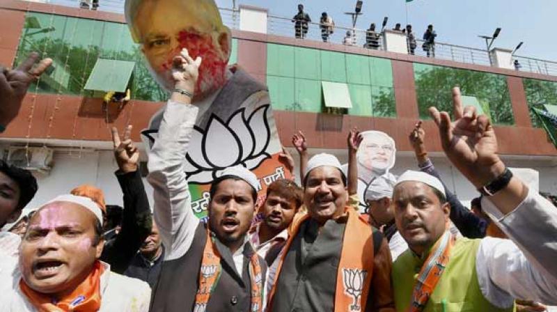 BJP supporters celebrate as early trends show the party's win in the last Uttar Pradesh and Uttarakhand assembly polls, at the party office in Lucknow. (PTI) BJP supporters celebrate as early trends show the party's win in the last Uttar Pradesh and Uttarakhand assembly polls, at the party office in Lucknow. (PTI)