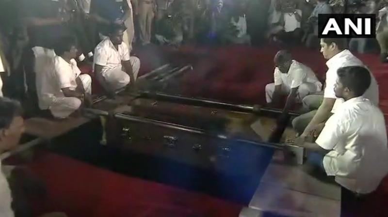 DMK chief M Karunanidhi being laid to rest at Marina Beach. (Photo: ANI) DMK chief M Karunanidhi being laid to rest at Marina Beach. (Photo: ANI)