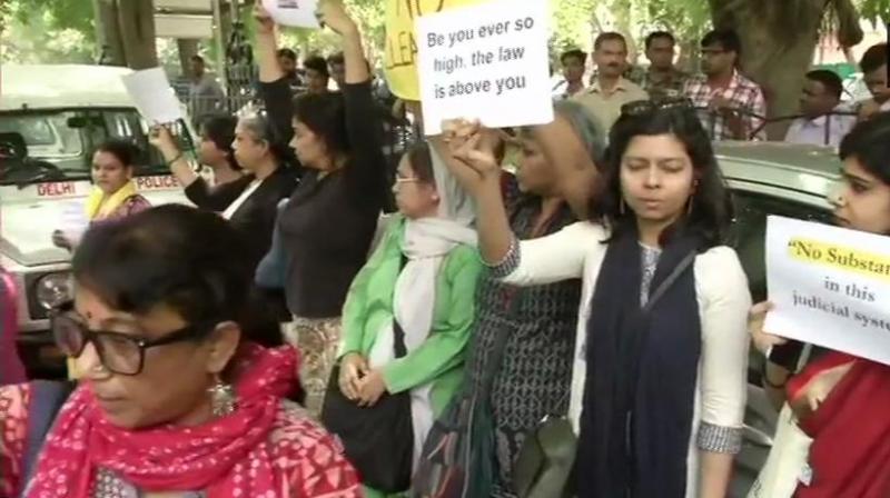 Some of the protestors who gathered outside the CJI’s house on Tuesday demanded the report should be shared with the woman. (Photo: ANI | Twitter) Some of the protestors who gathered outside the CJI’s house on Tuesday demanded the report should be shared with the woman. (Photo: ANI | Twitter)