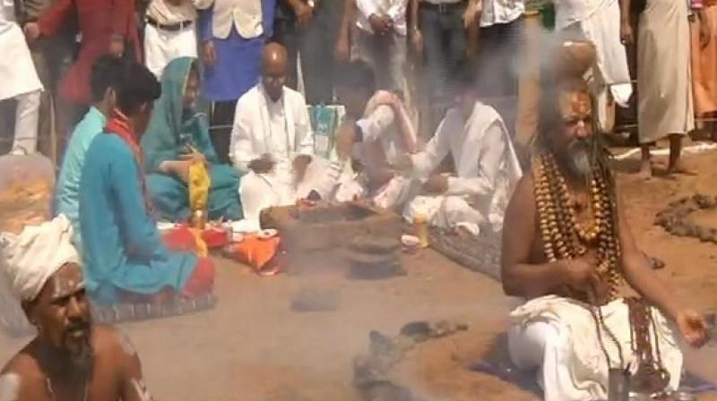 At the 'pooja' Digvijaya is seen dressed in white kurta pyjama seated on the ground while others surround him in a semi circle. (Photo: ANI) At the 'pooja' Digvijaya is seen dressed in white kurta pyjama seated on the ground while others surround him in a semi circle. (Photo: ANI)